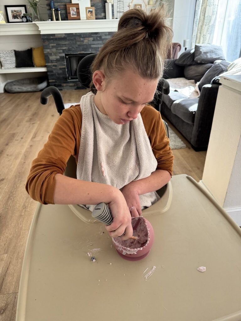 Teen girl scooping food out of bowl