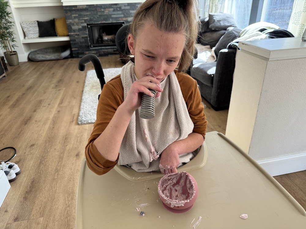 Girl eating with adaptive spoon